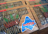 Wakasagi no Tsukudani-Ikadayaki, pond smelt boiled in sweet soy, grilled on sticks
